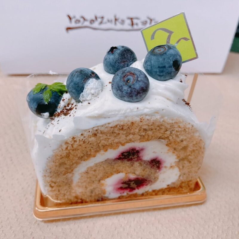 ロールケーキの上にブルーベリーがのっているおいしそうなケーキ